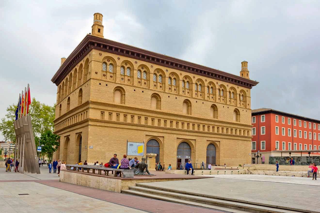 a group of people sitting on a bench in front of a building