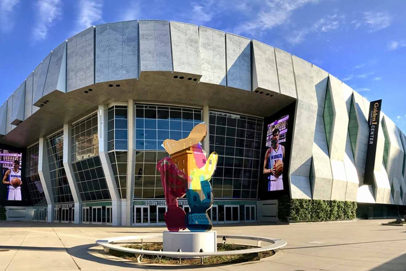 A large building with a statue in front of it.