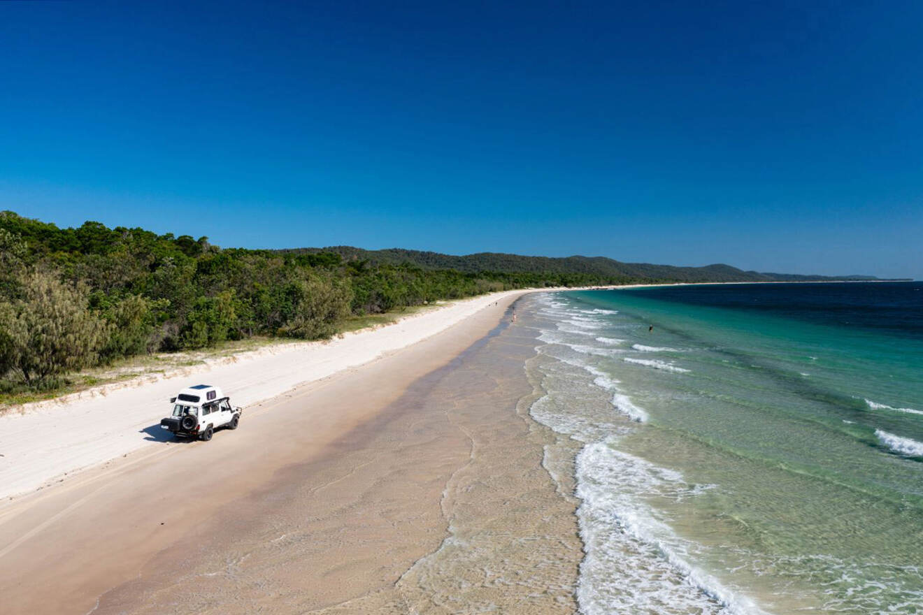 A jeep is parked on a sandy beach