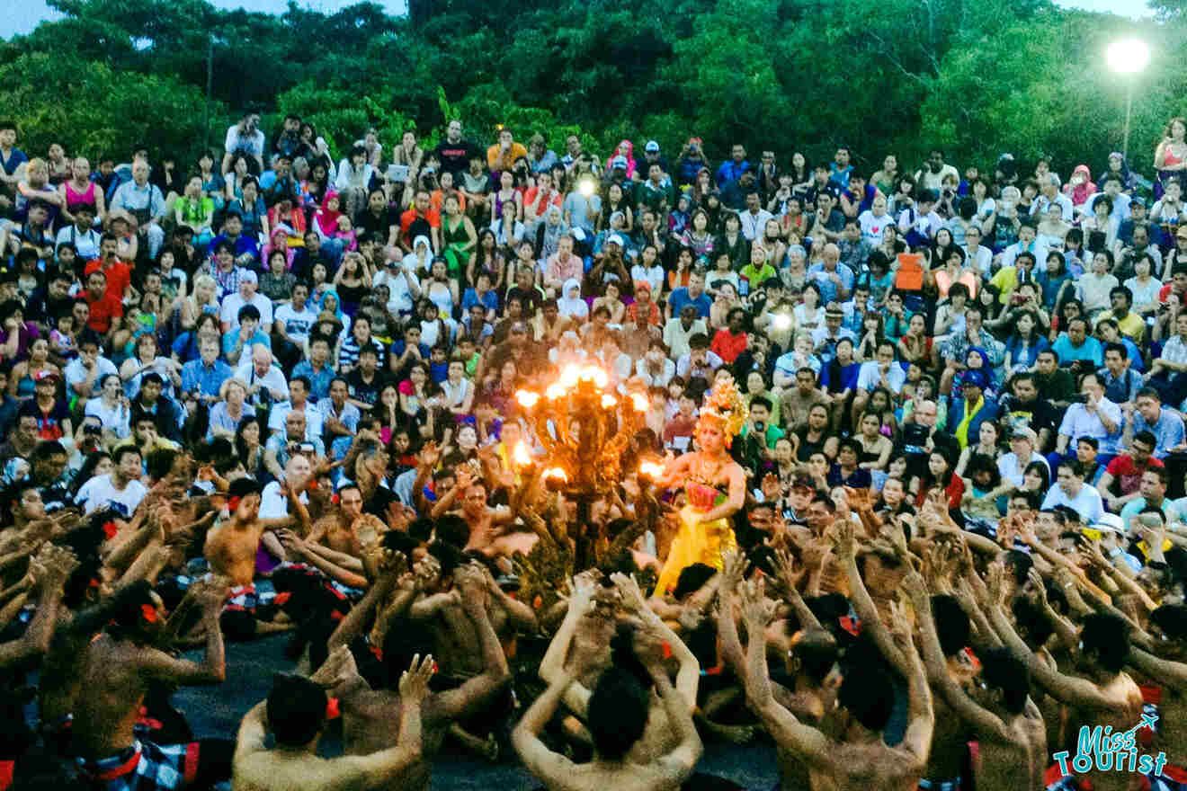 A large crowd of people in front of a fire dance