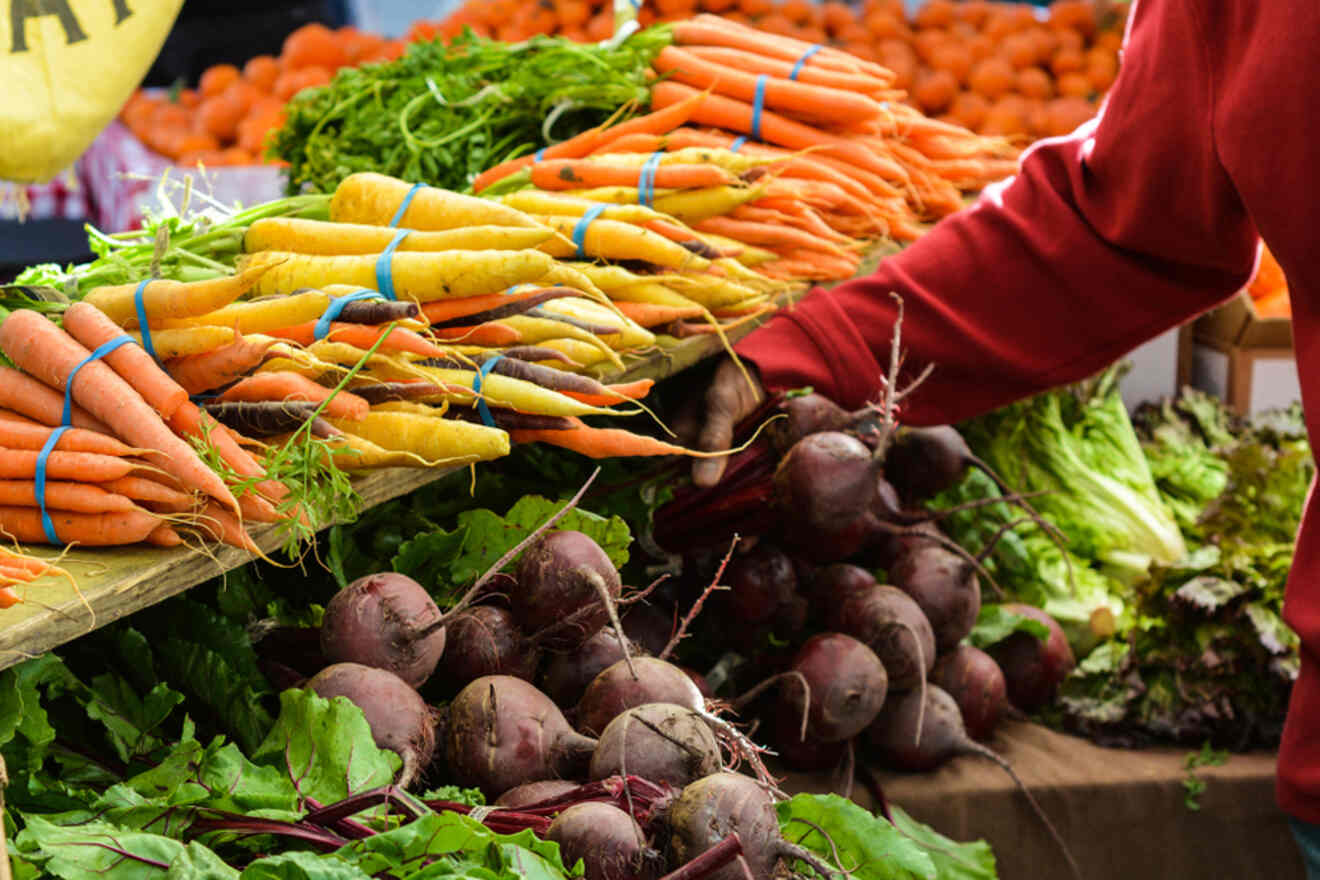 A man buying vegetables at a market.