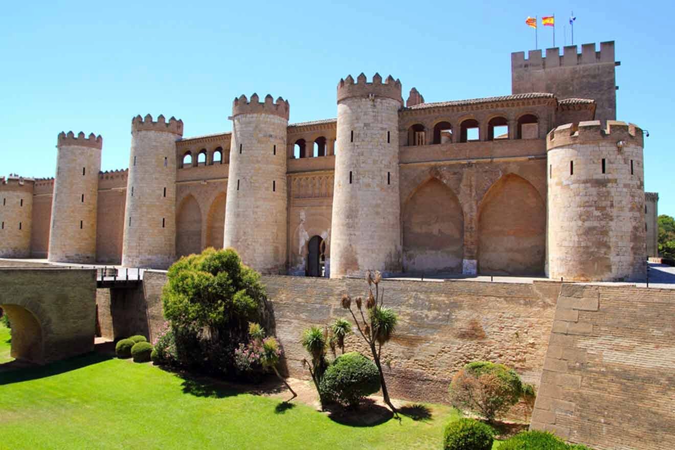 a castle with towers and a bridge in front of it