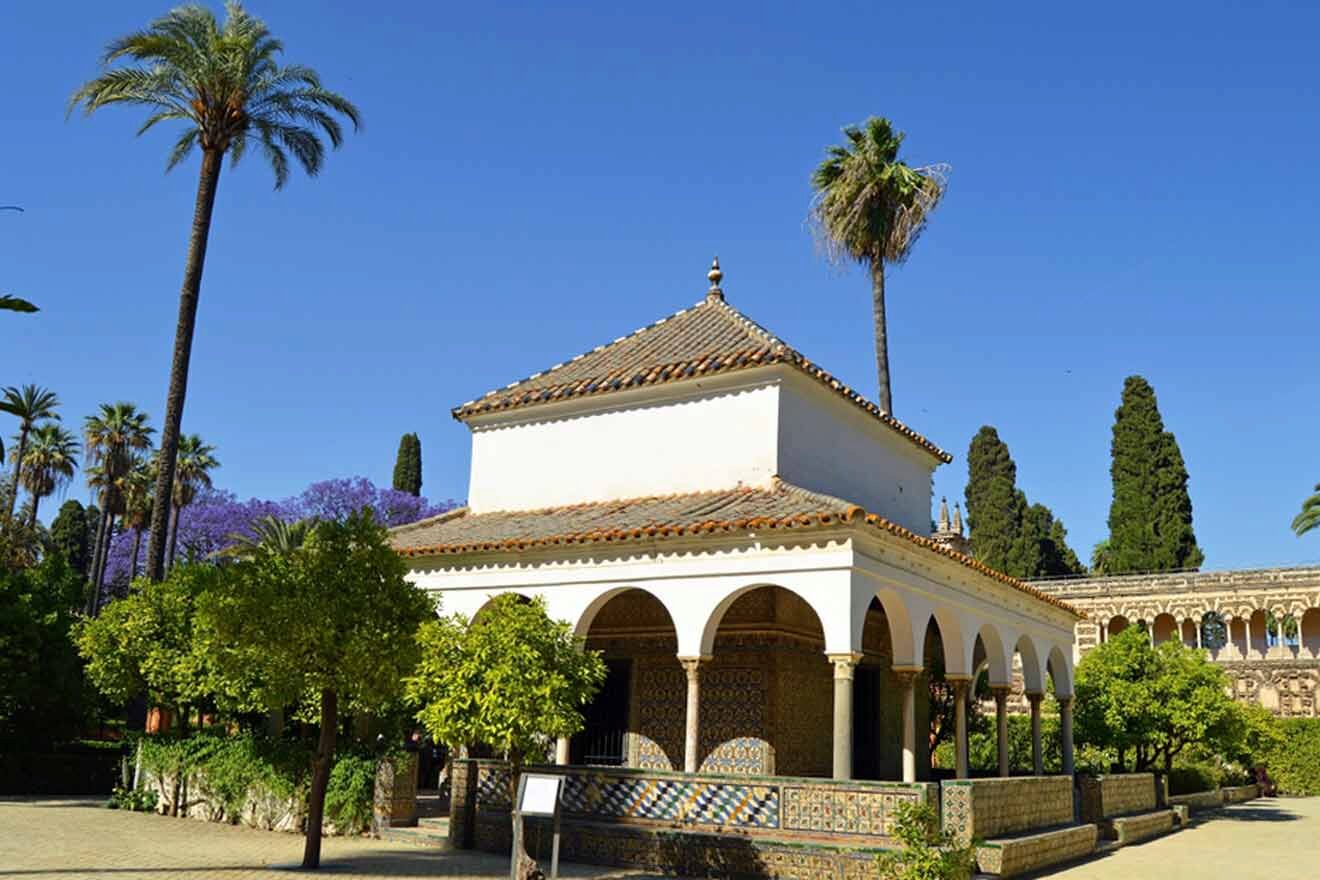 white building with arches and surrounded by trees