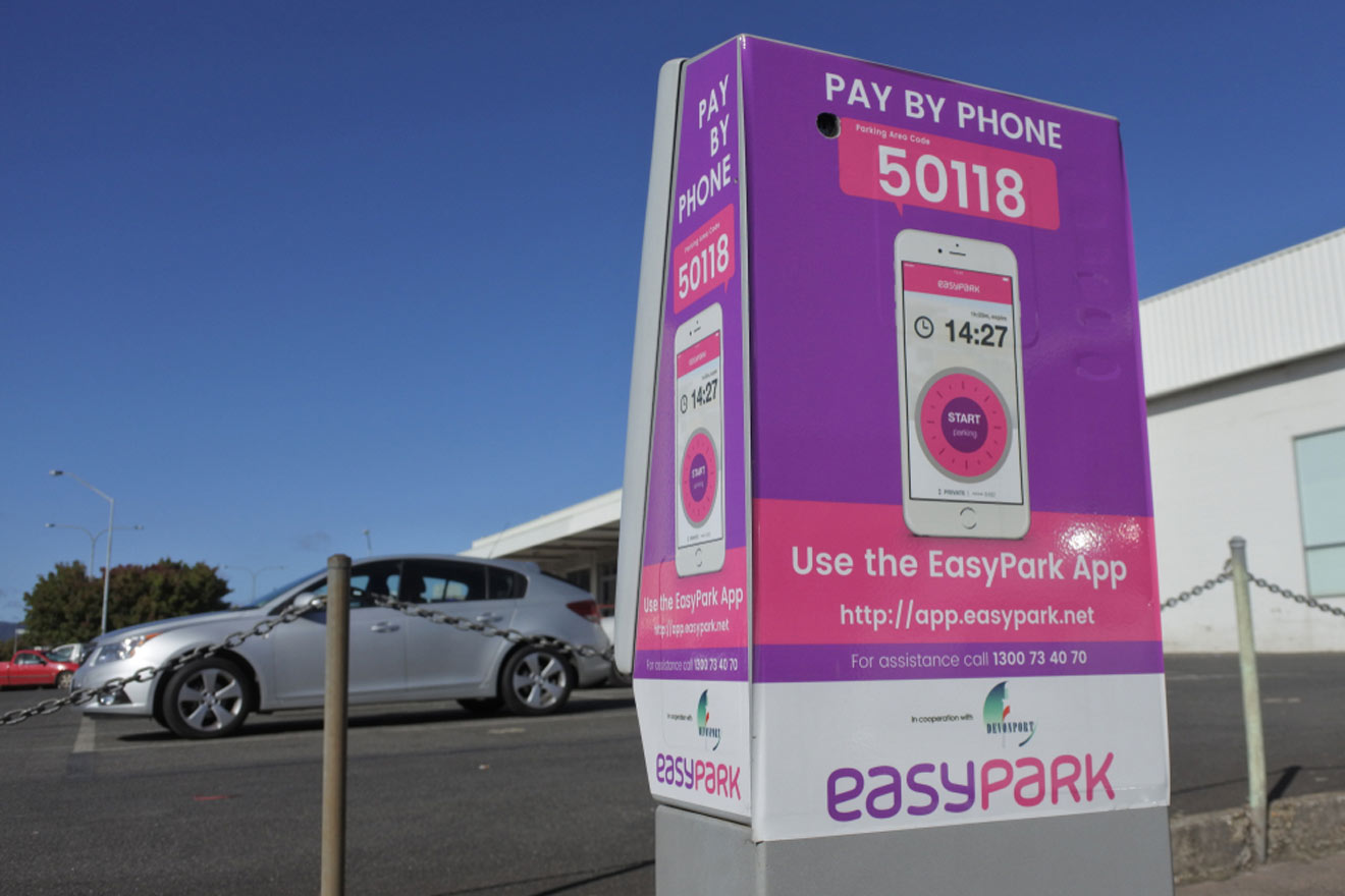 An easy park sign in front of a building.