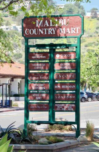 wooden sign with lots of shops and restaurants in the malibu country mart