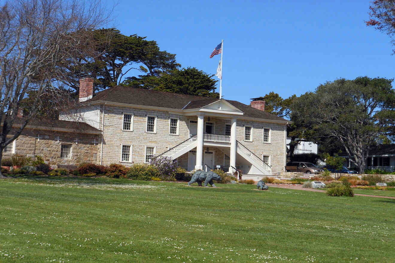 A large stone building with a flag on top of it.