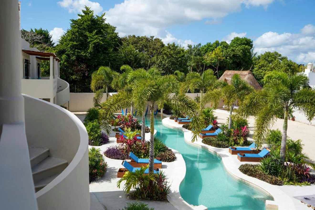 A resort with a pool and lounge chairs and palm trees