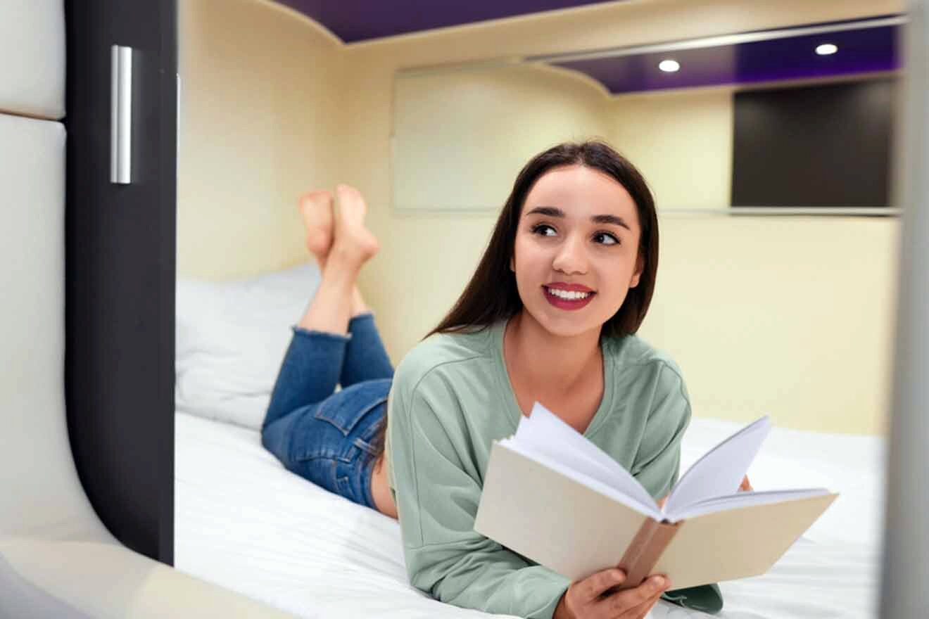 a woman laying on a bed reading a book