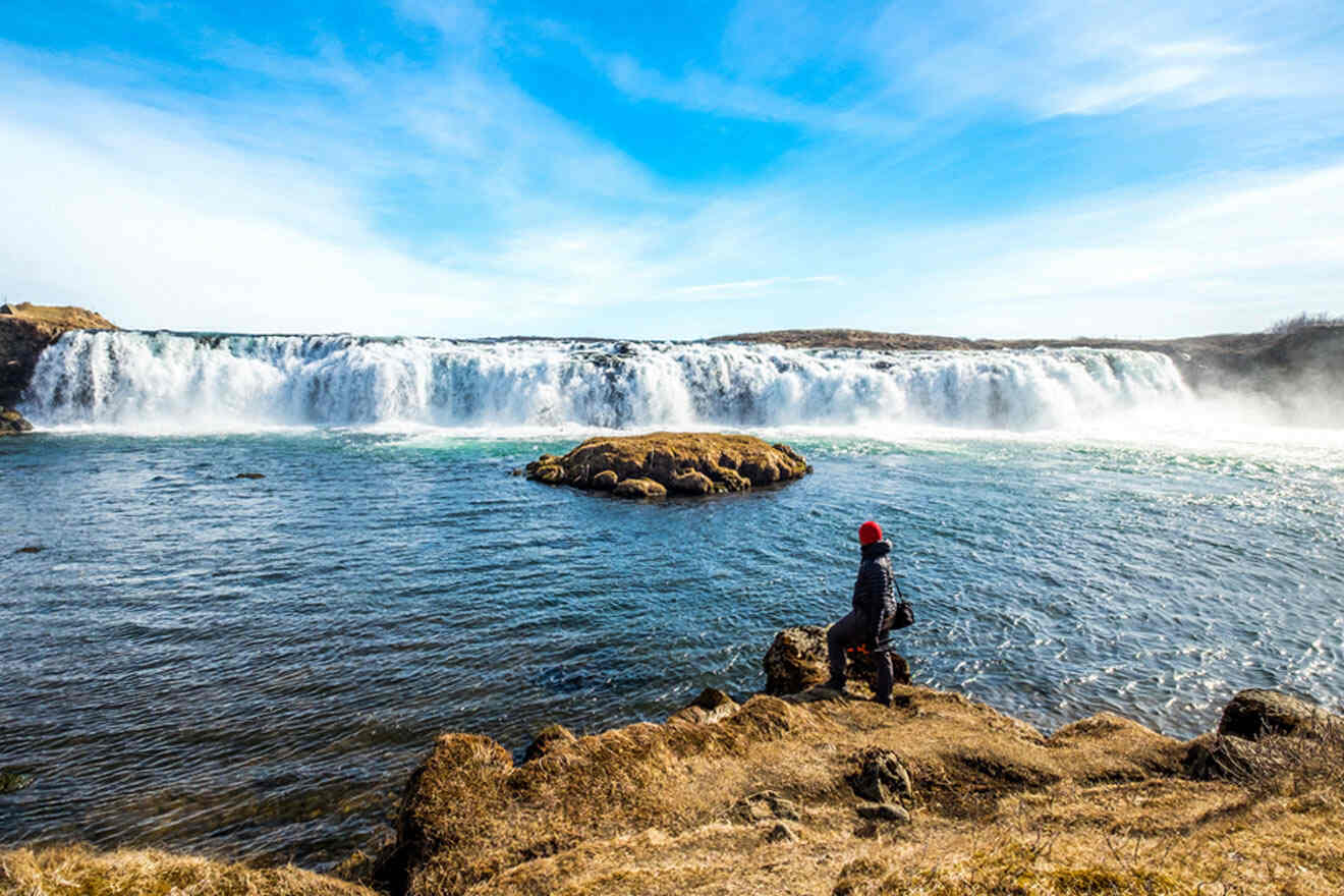 person looking at a waterfall