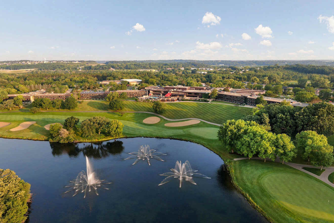 An aerial view of a golf course with fountains and trees.