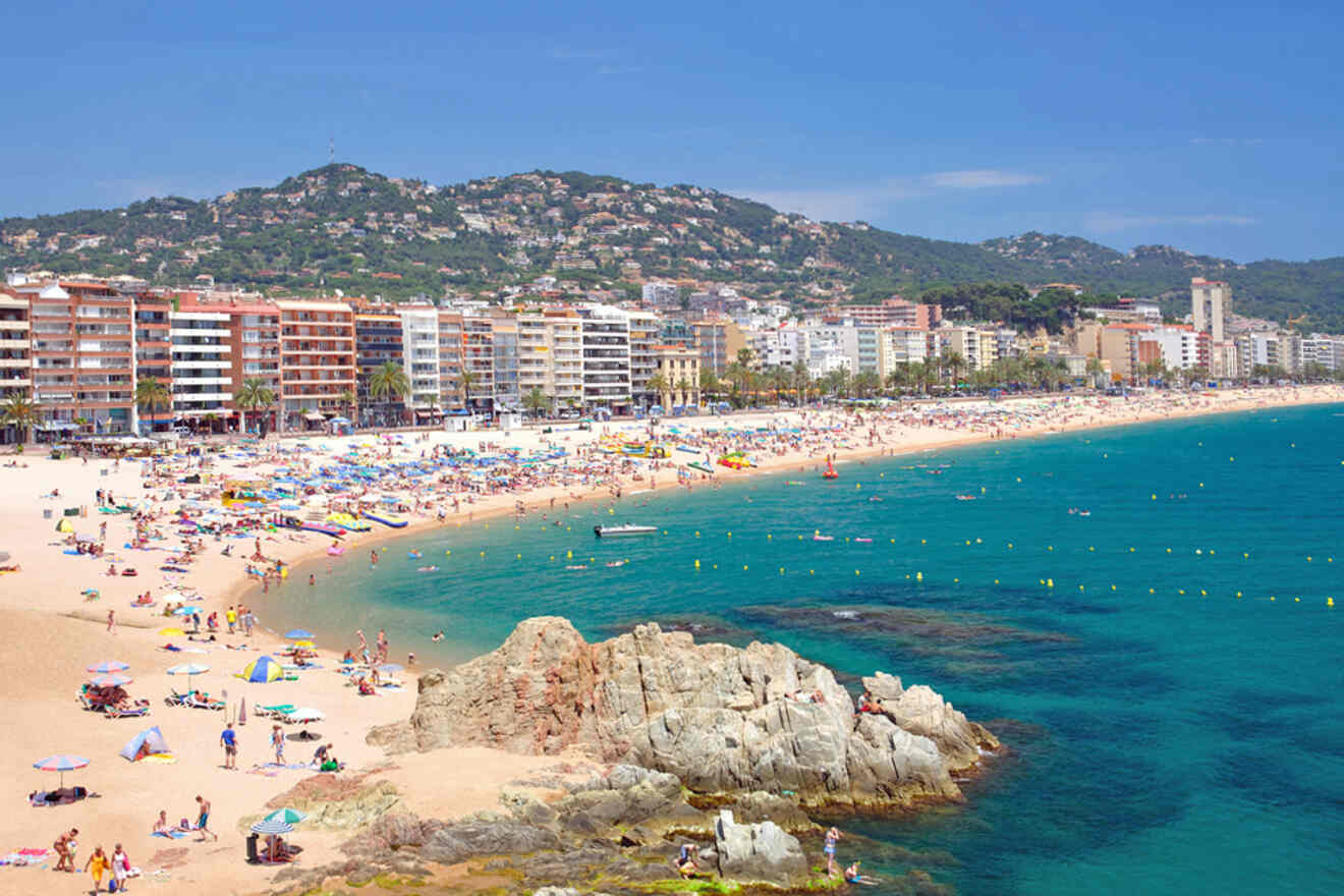 A beach with a lot of people on it.