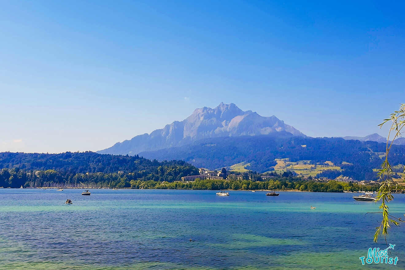 A lake in switzerland with mountains in the background.