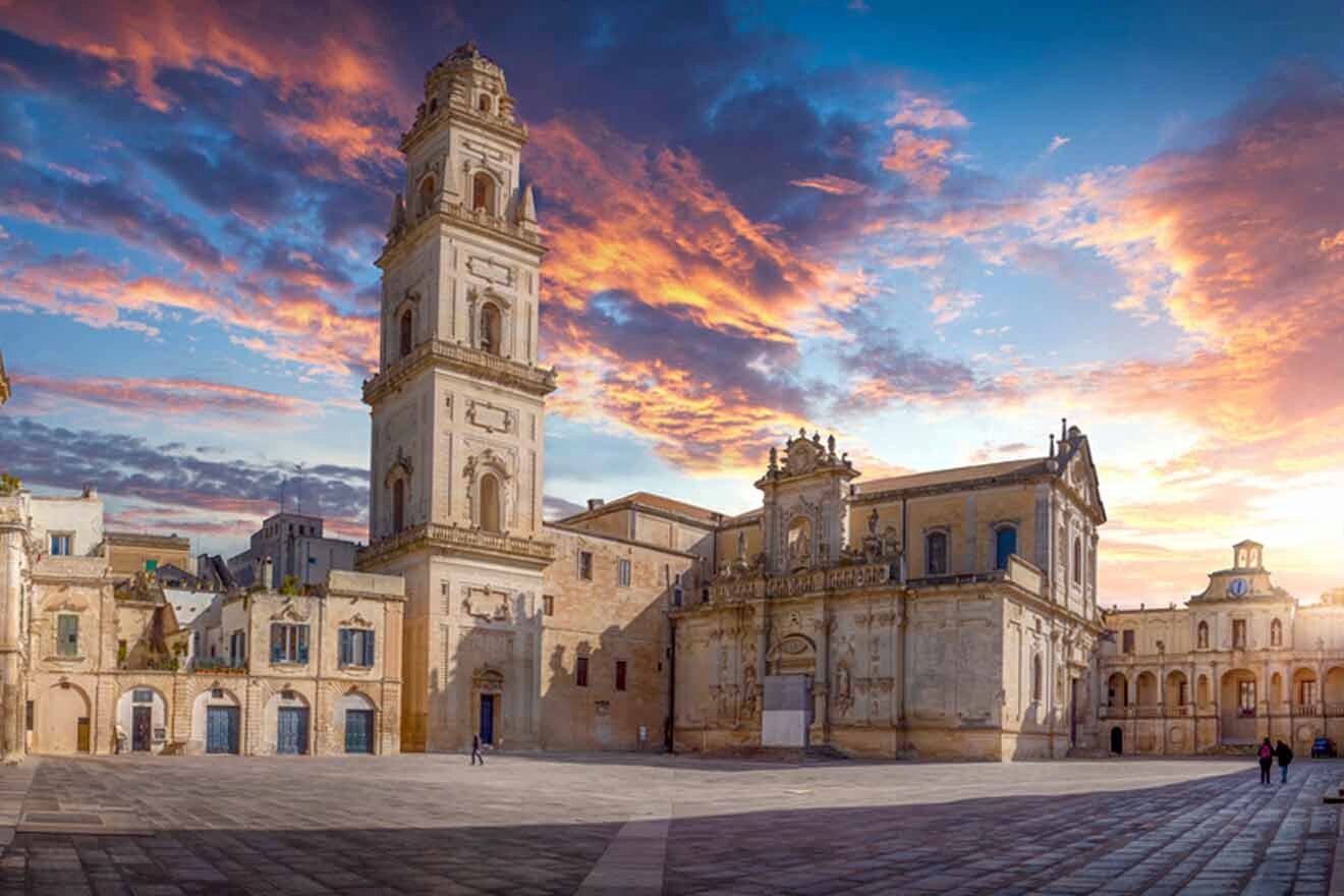 a large building with a clock tower on top of it at sunset