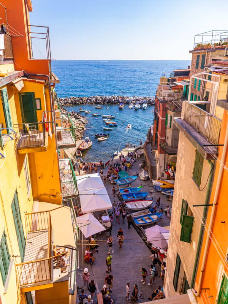 colorful buildings on narrow road leading to harbor