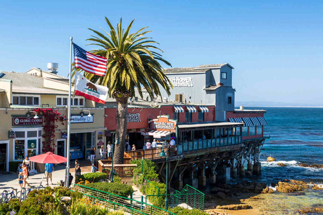 An american flag is flying over a pier with a view of the ocean.