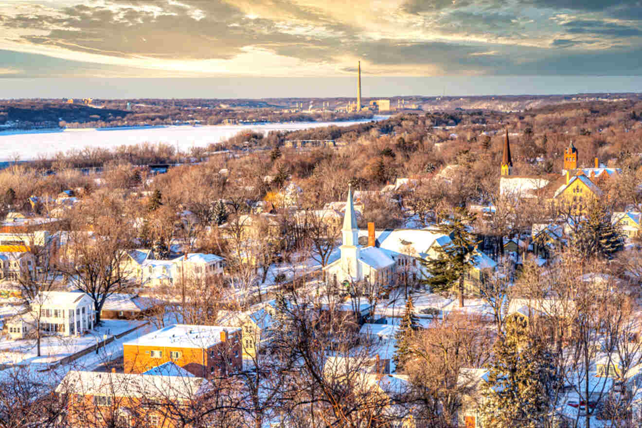 A view of a town in winter with snow on the ground.