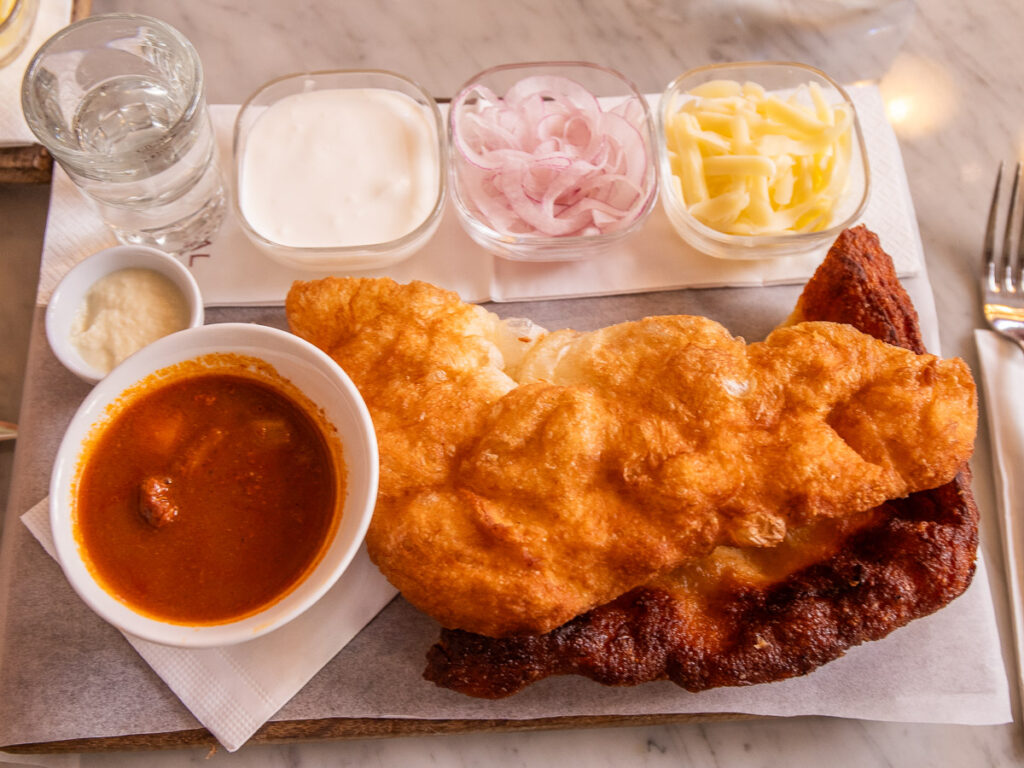 Fried flatbread on a plate with onions and cheese