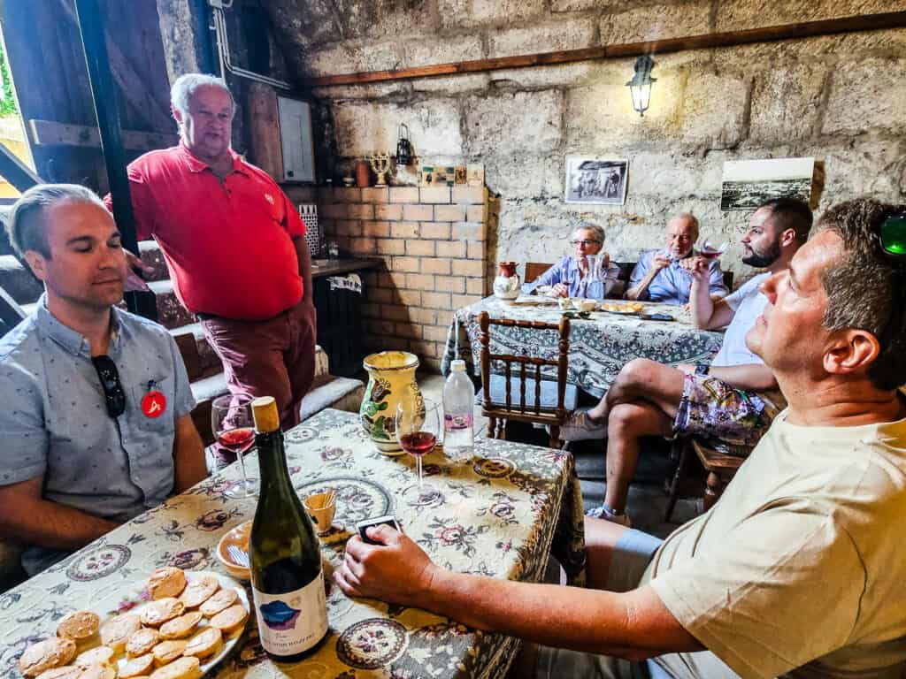 People sitting at a table tasting wine