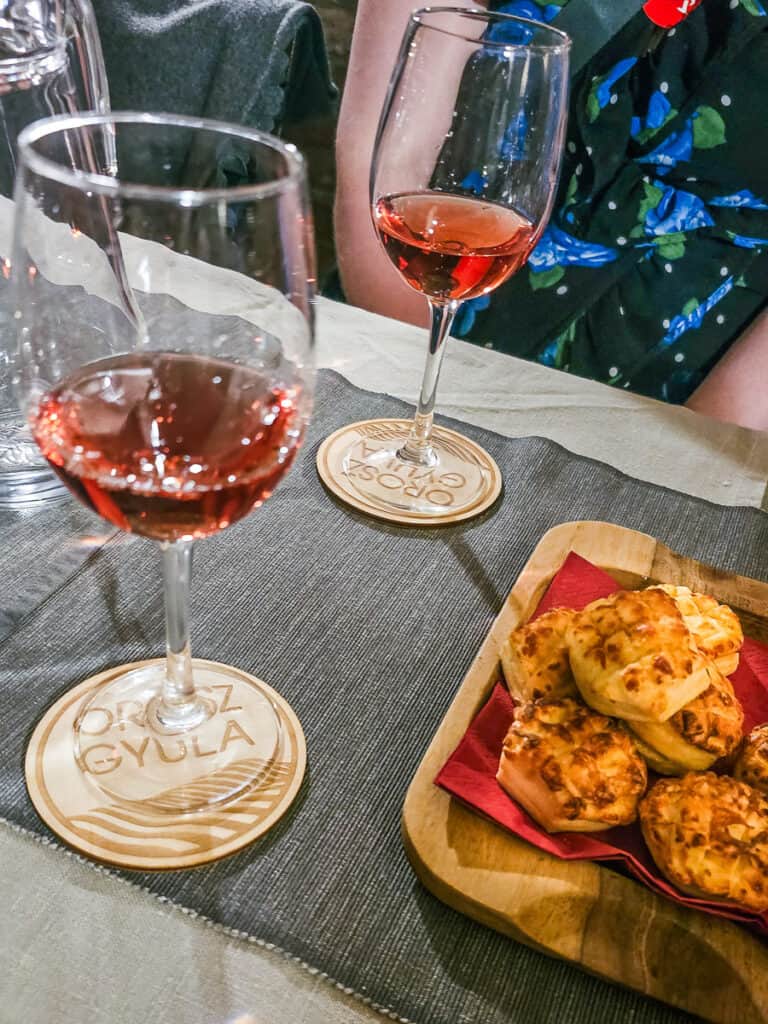 Two glasses of wine and scones on a tray