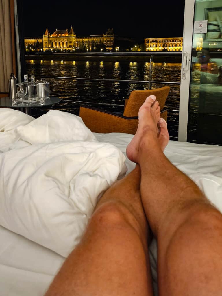 Legs on a bed with a city skyline in background