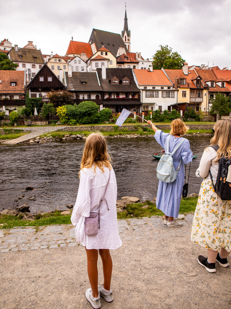 Young girl on a tour of a city with pretty houses in the backdrop