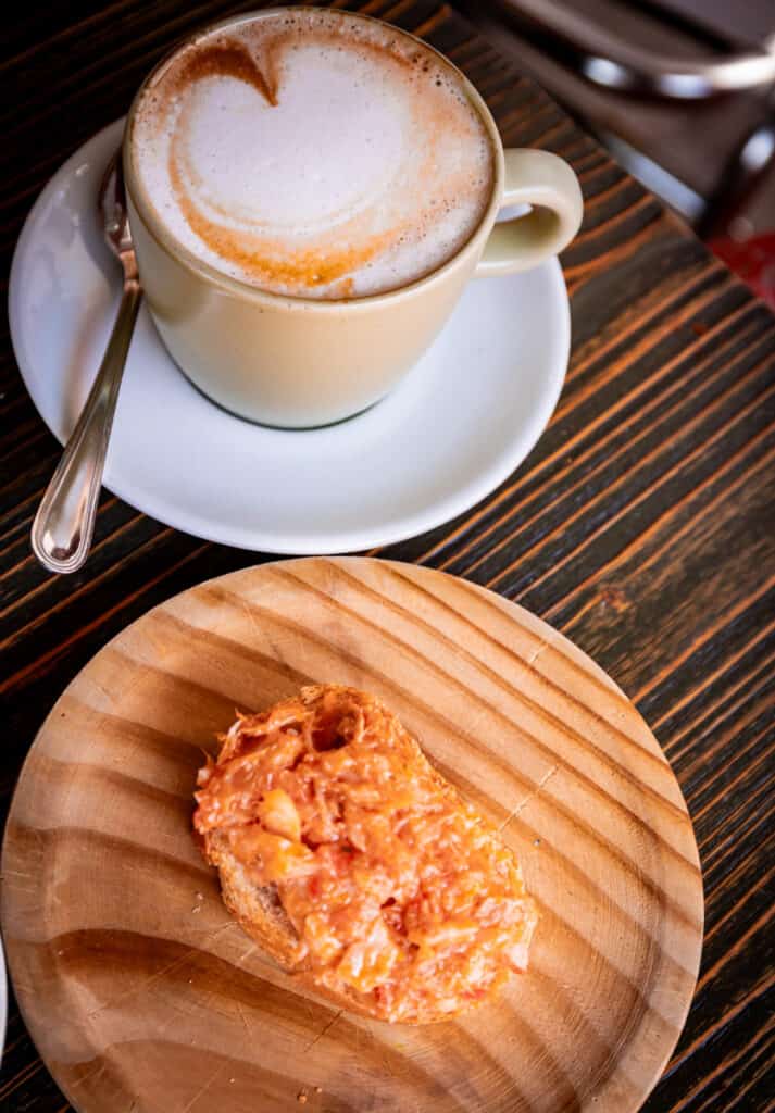 Capuchino and chicchetti on table 