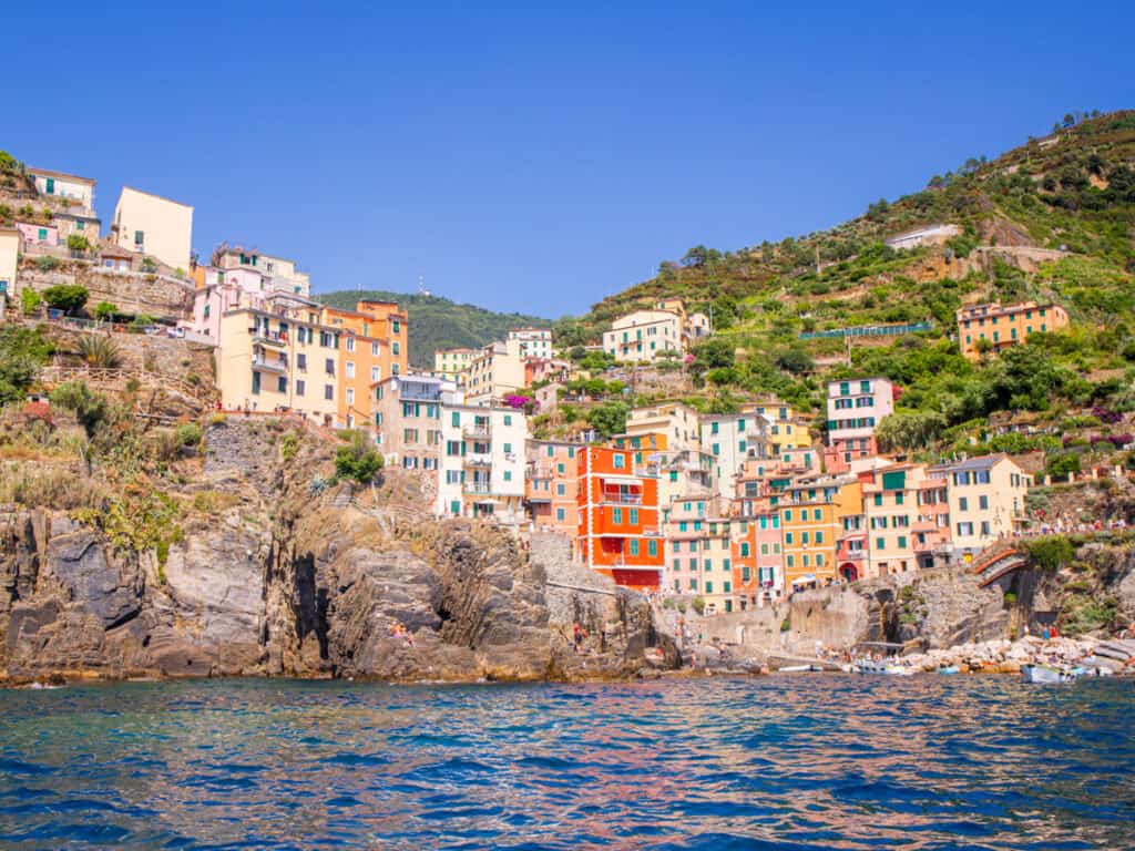 colored biuldings of riomaggiore on cliff face