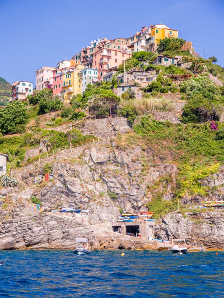 colored buildings of corniglia on top of hill