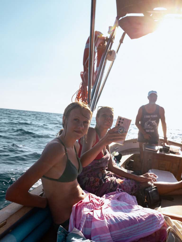 caroline and kalyra taking photos on boat