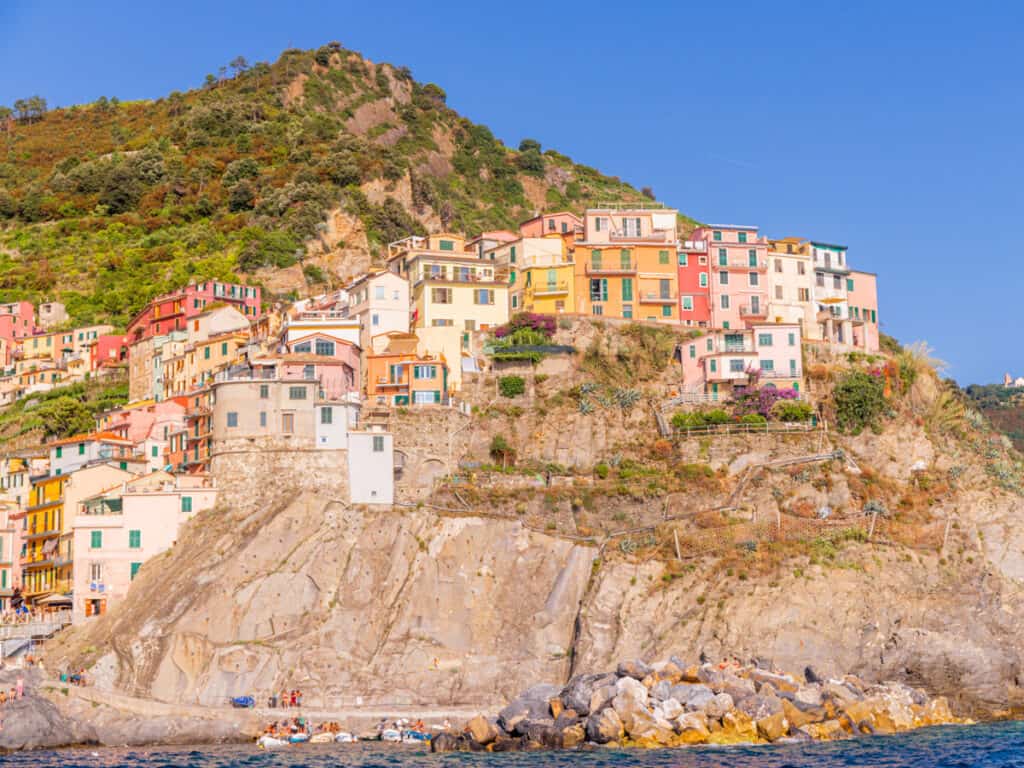 colored buildings of manarola on cliff face