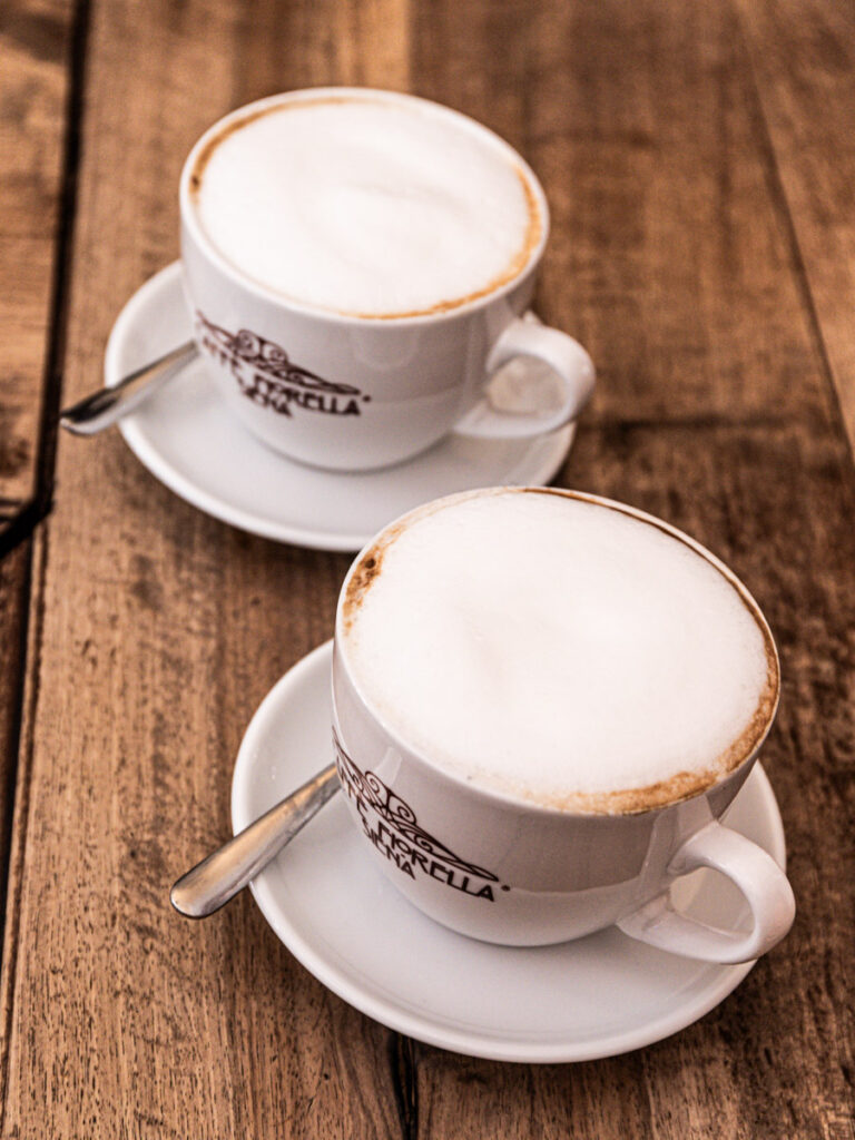 two cappuccinos on table