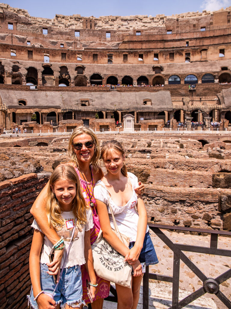 caz and the girls smiling at camera inside colosseum