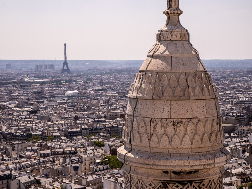 view of eiffel tower and basilica steeple facing off 