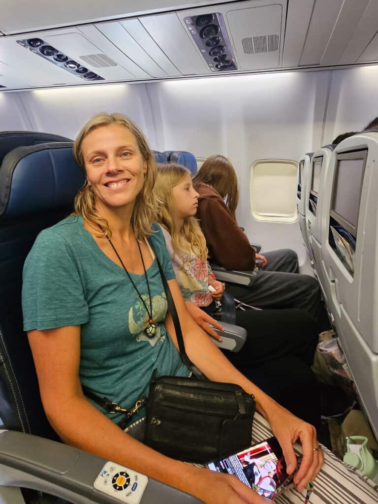 Mom and two daughters on a plane