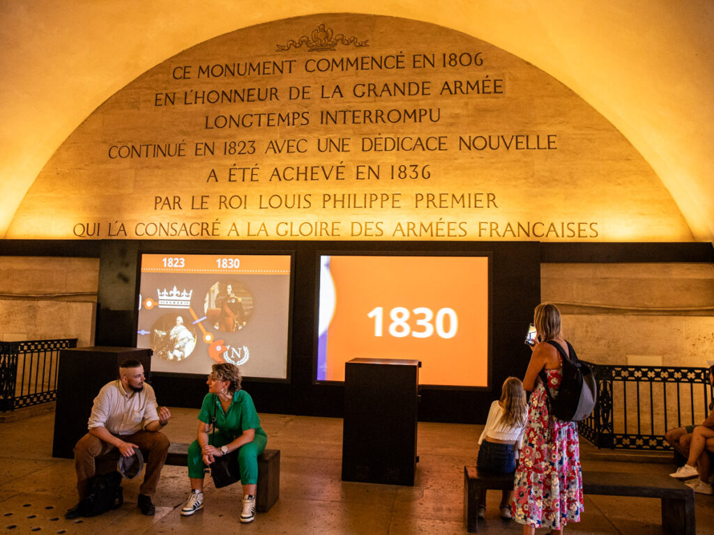 caz looking at exhibition inside arc de triomphe