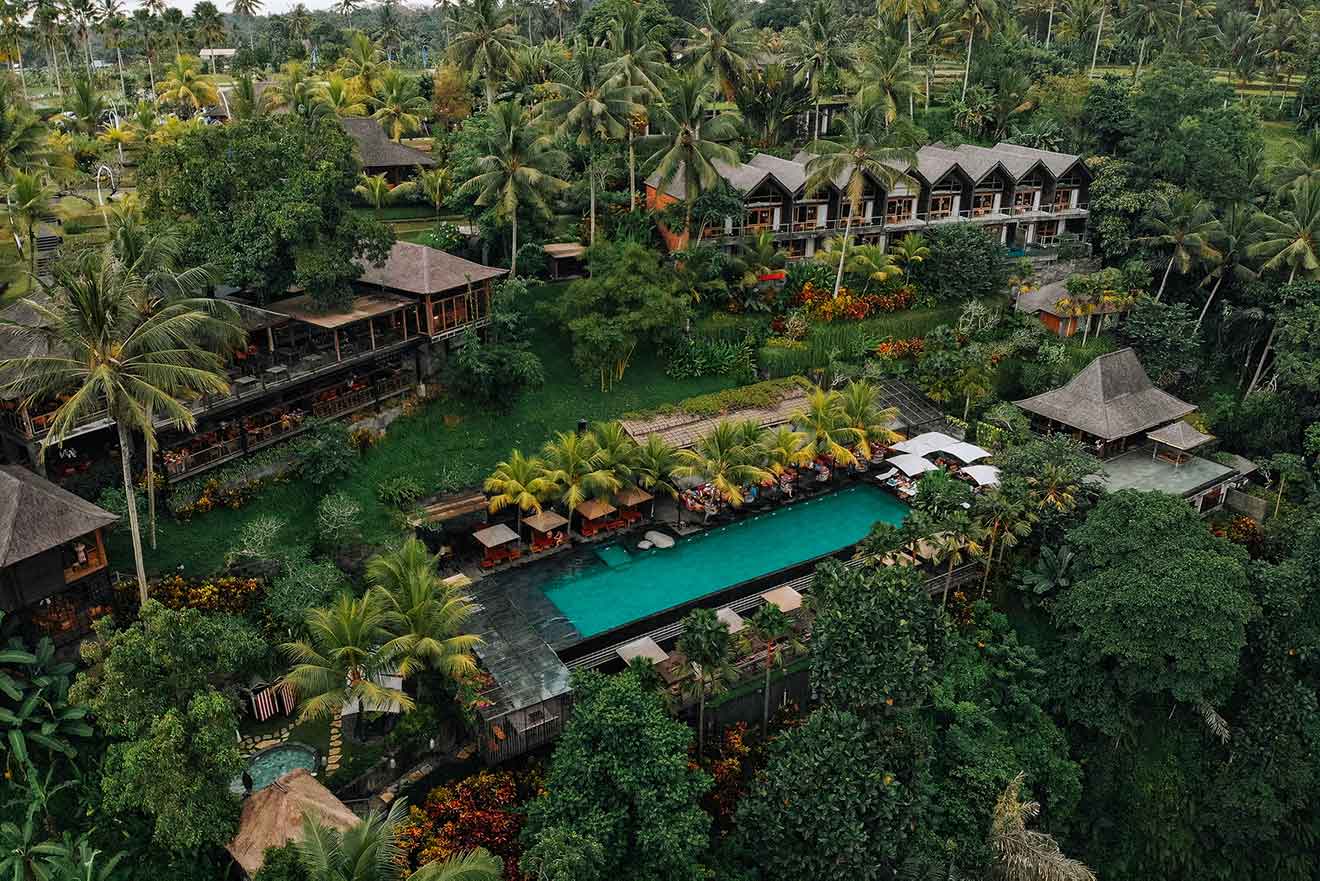 a large swimming pool and houses surrounded by trees