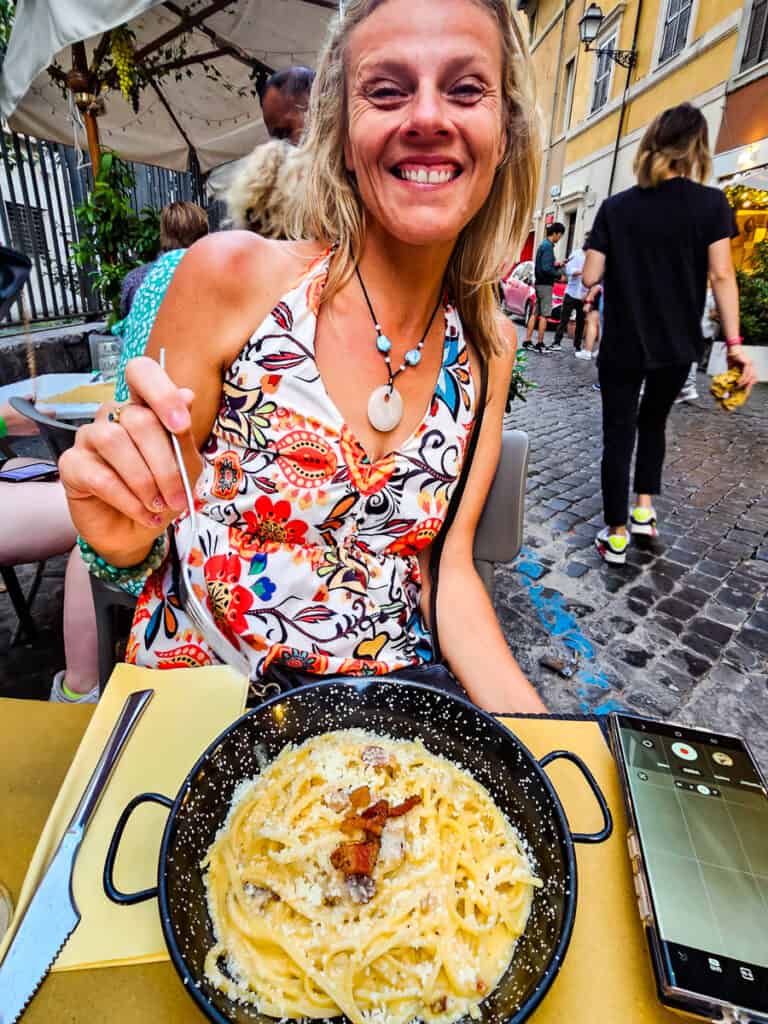 Lady eating a bowl of pasta