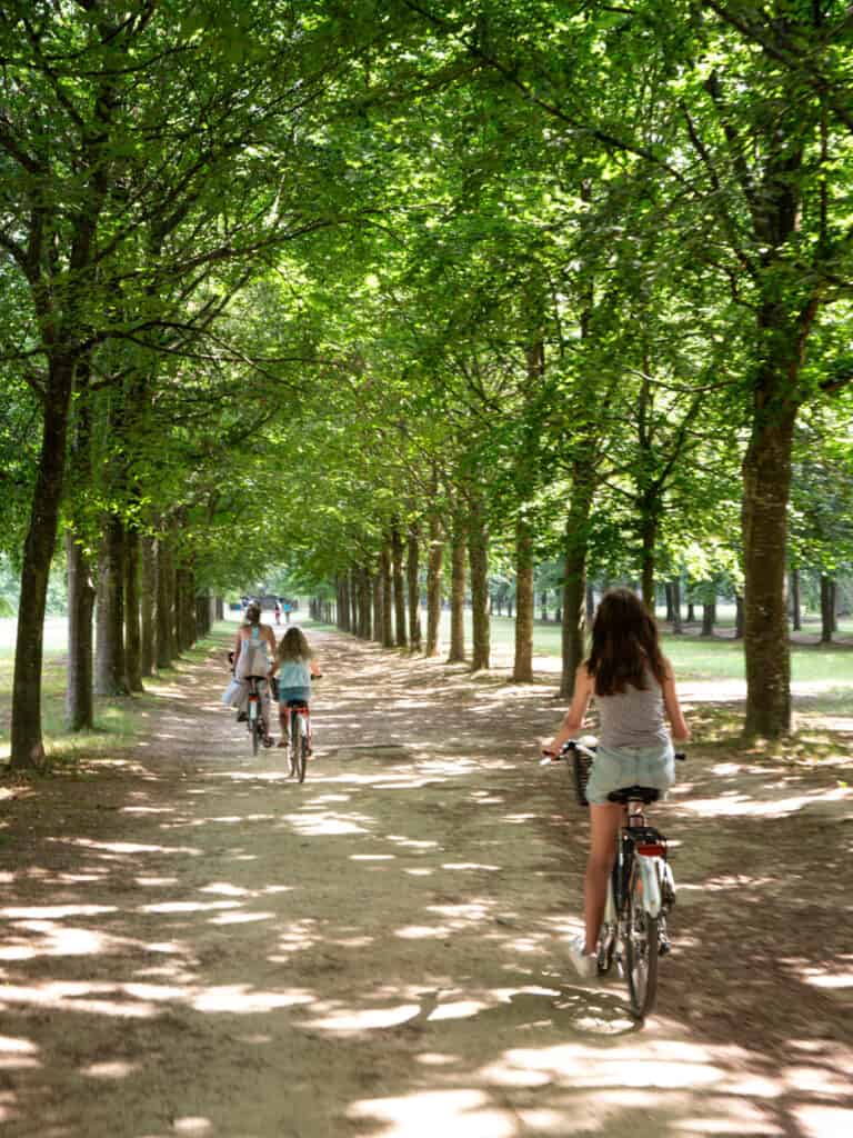 caz and the girls riding bikes on versailles estate