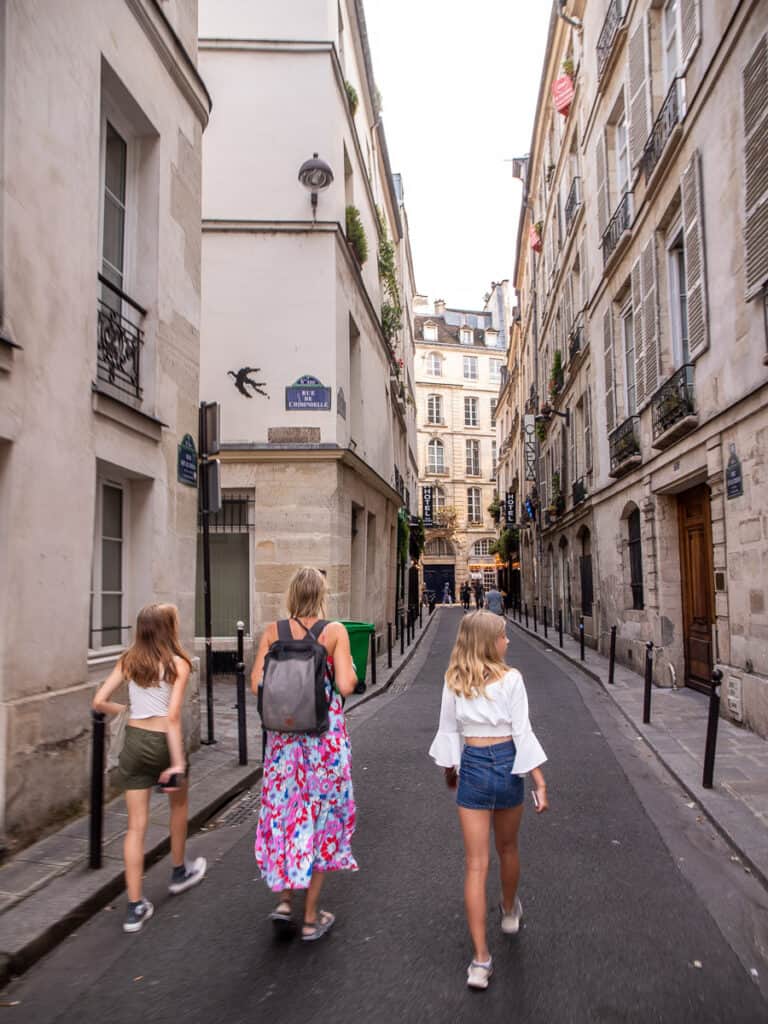 Mom and two daughters walking walking the streets of Paris