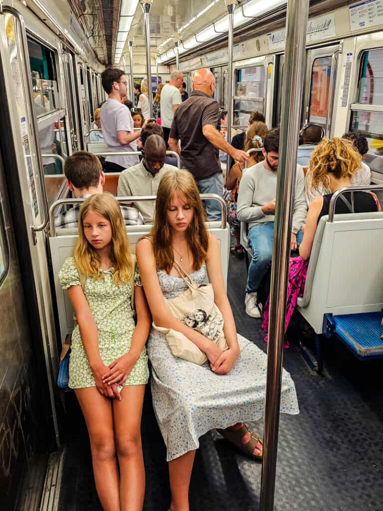 Two girls riding a train