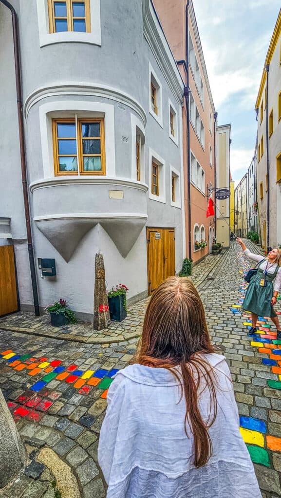 Young girl looking at a building in an alleyway