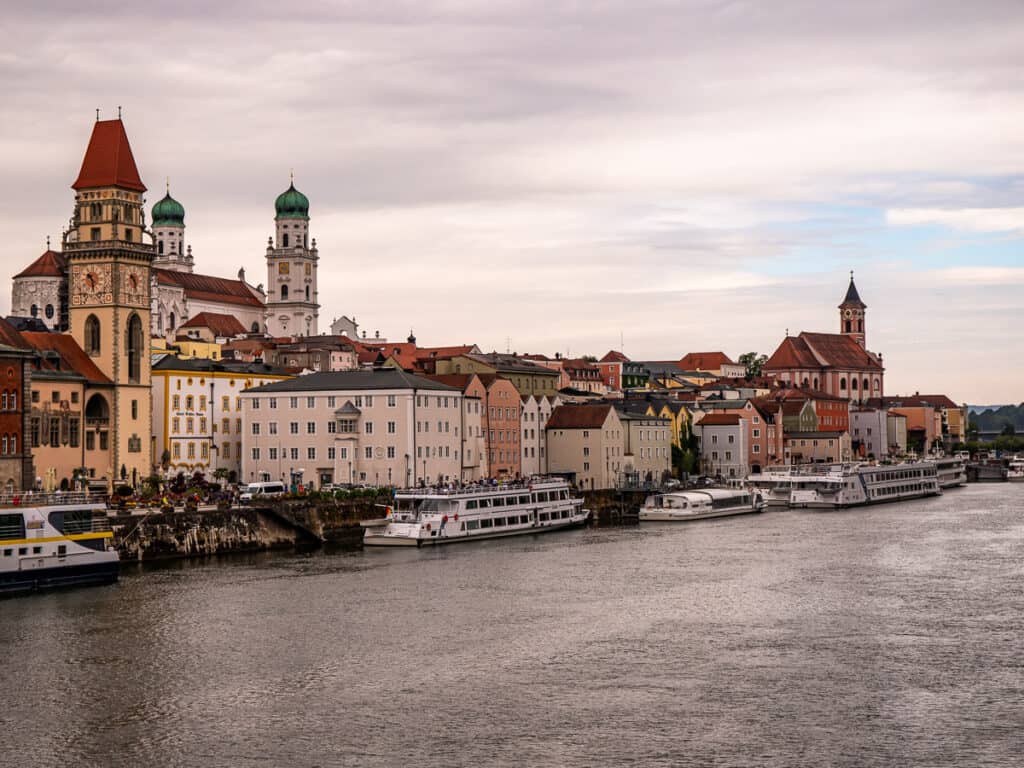 River cruise ship in dock with a city backdrop