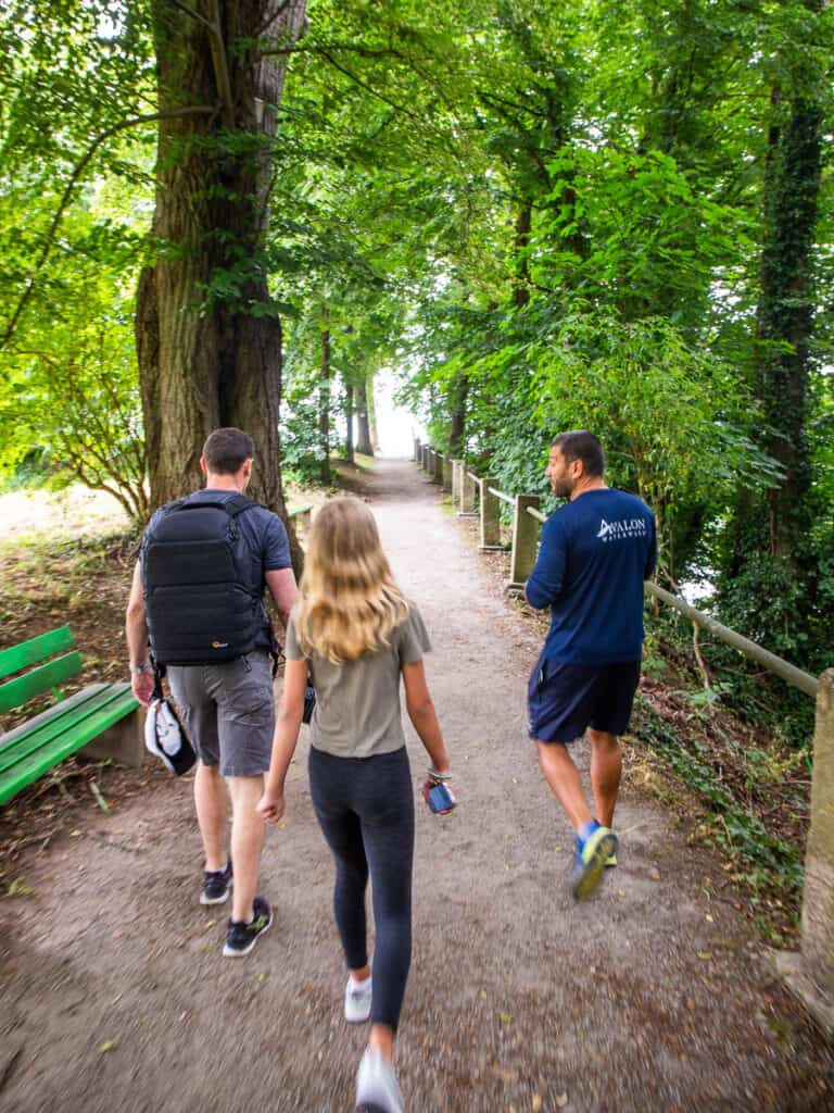 Girl and two men walking a path in the forest