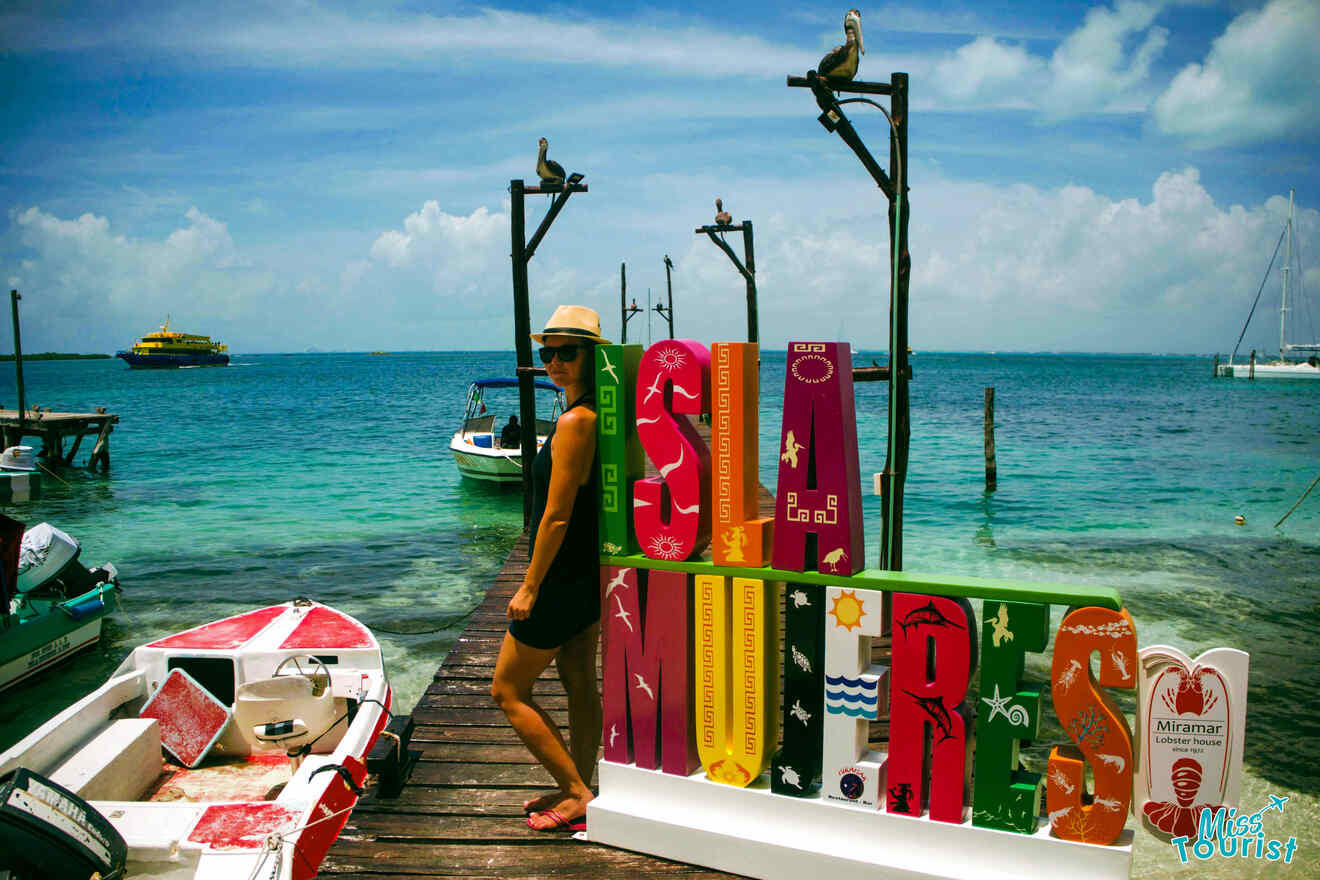 A woman standing on a dock next to a boat.