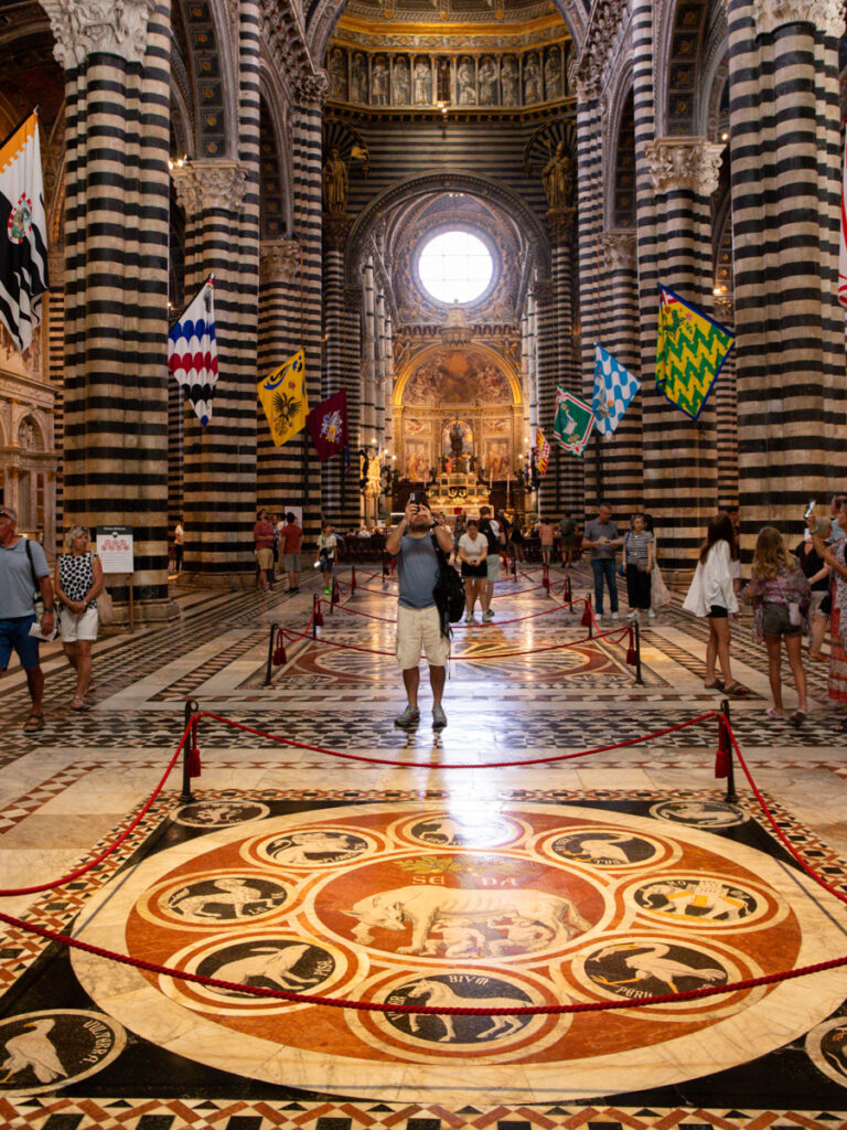 man taking photo of walls and floor inside the church