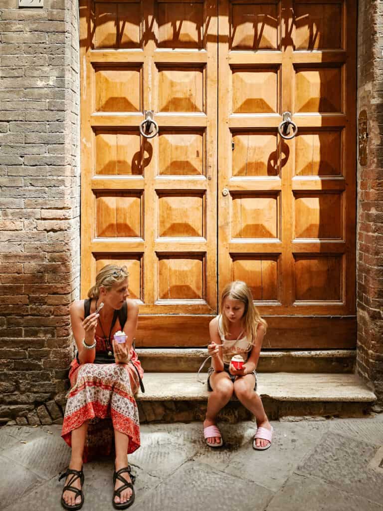 caz and savannah sitting in doorway eating gelato