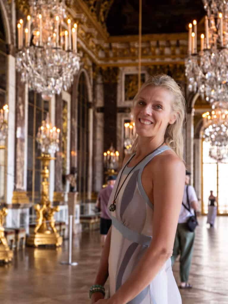 caz posing inside hall of mirrors