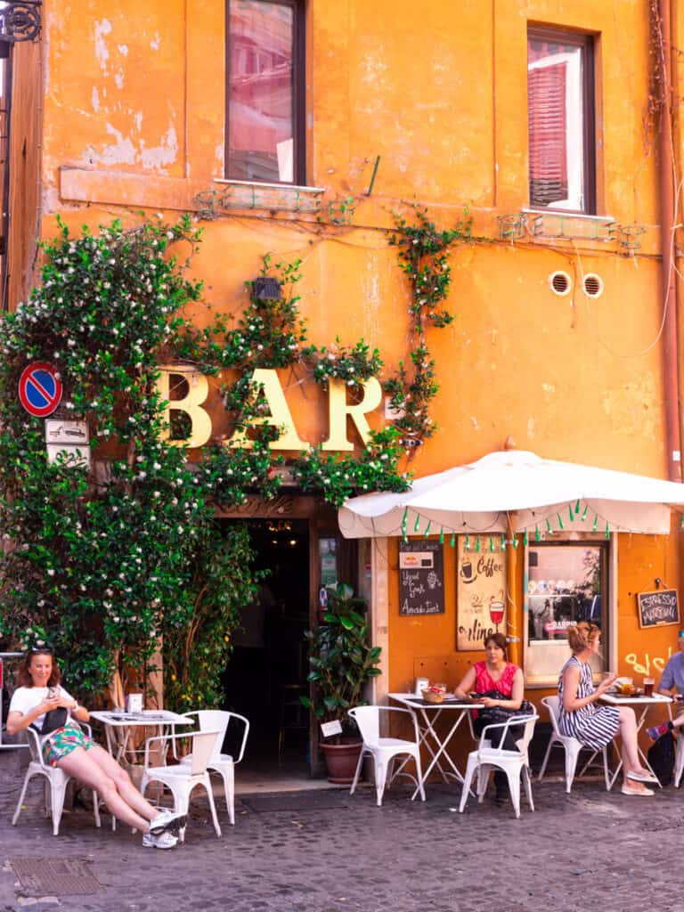 people sitting outside bar in trastervere