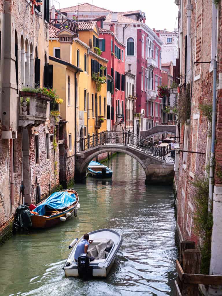 boat going down canal in venice