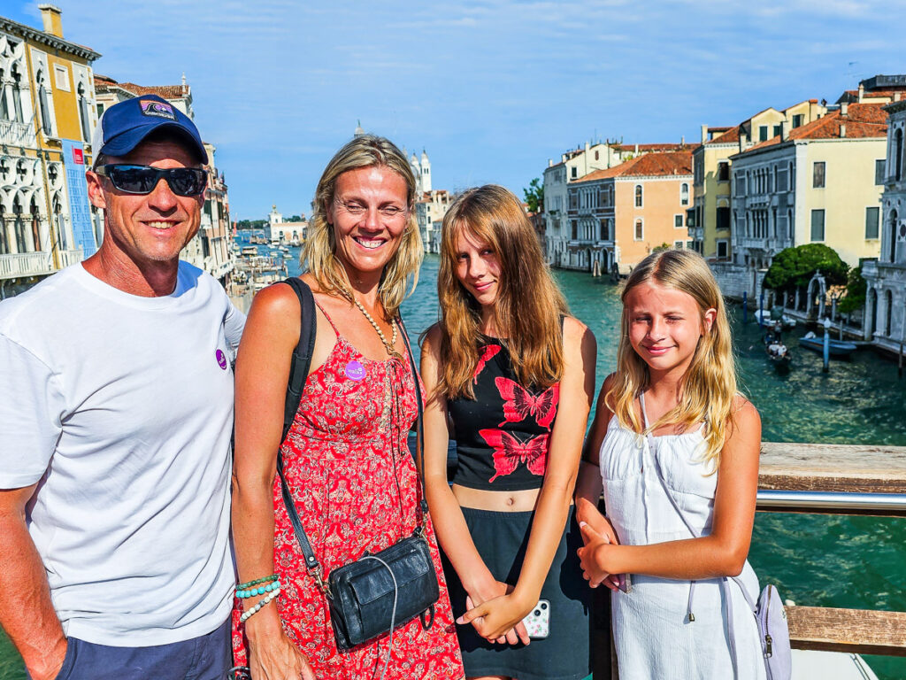 makepeace family on accademia bridge in venice smiling at camera